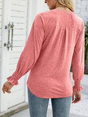 Burnt Coral jersey v-neck top with gathered cuff long sleeves and back pleats.