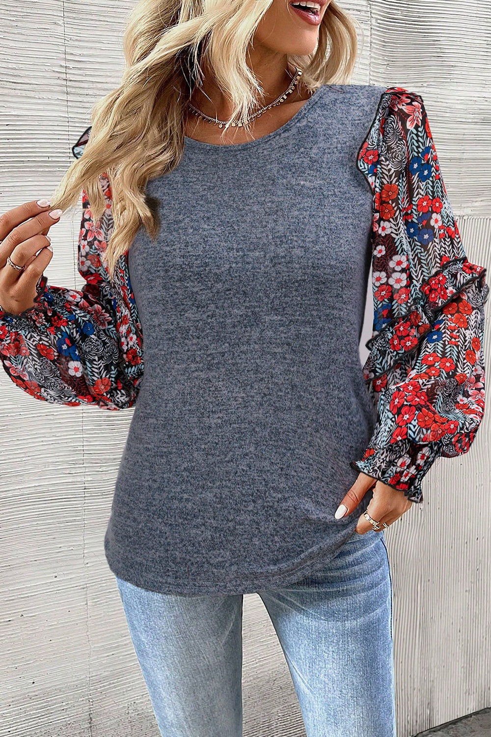 Dark gray knit top with floral chiffon puff sleeves and ruffled cuffs.