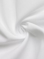 White polyester fabric detail of a midi shirt dress with a bow tie and button front.