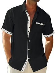 Black waffle weave short sleeve shirt with airplane print contrast trim and pocket.
