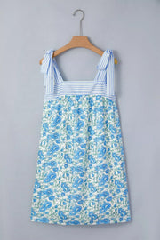 Botanical print mini dress with tie straps and blue stripe bodice detail.