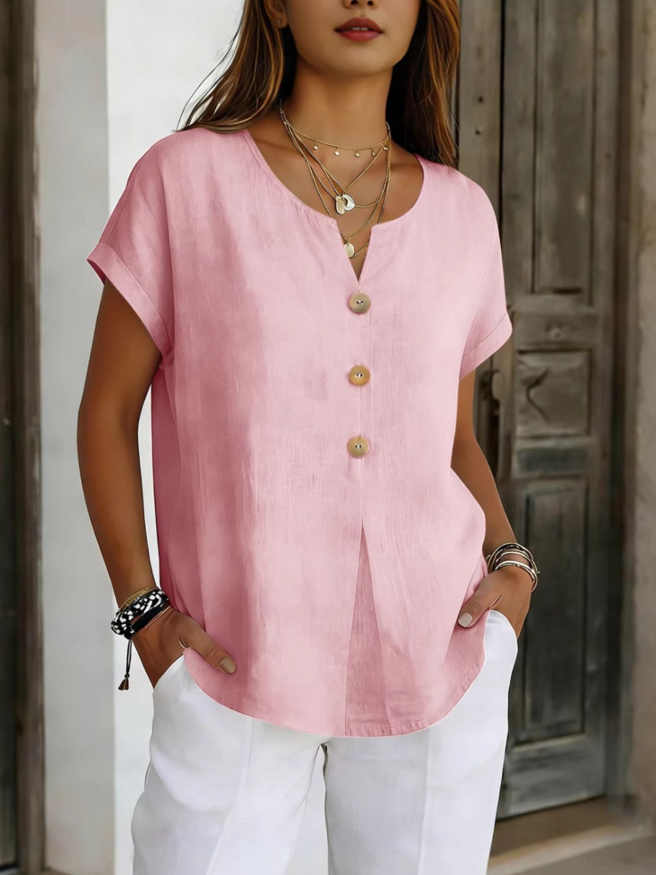 Dusty Pink buttoned short sleeve blouse with a V-neck and rolled cuffs.
