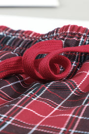 Joggers with red plaid pattern and red drawstring detail.