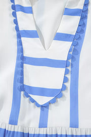 Tiered vacation dress with blue and white stripes, V-neck, and ricrac trim.