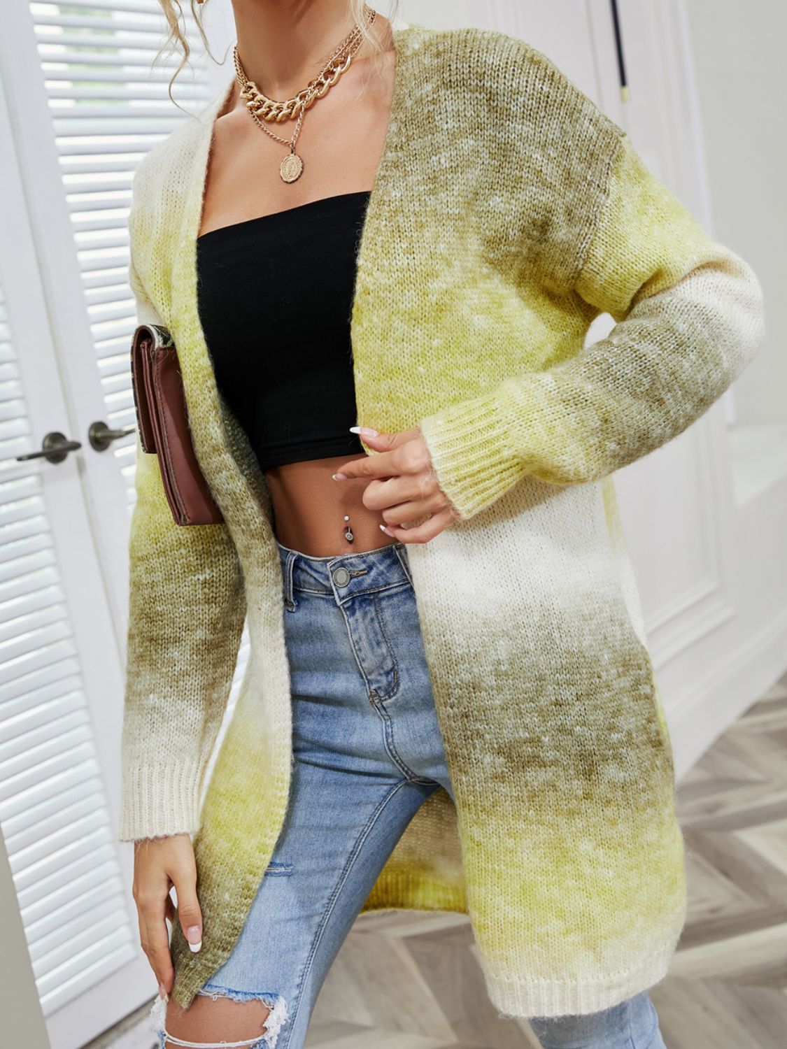Rainbow gradient knit cardigan with pockets, open front, long sleeves, and a relaxed fit.
