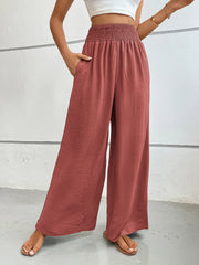 Rust textured palazzo lounge trousers with smocked waist and wide legs.