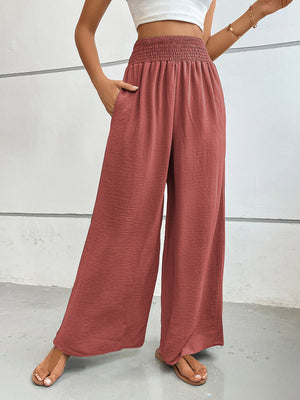 Rust textured palazzo lounge trousers with smocked waist and wide legs.