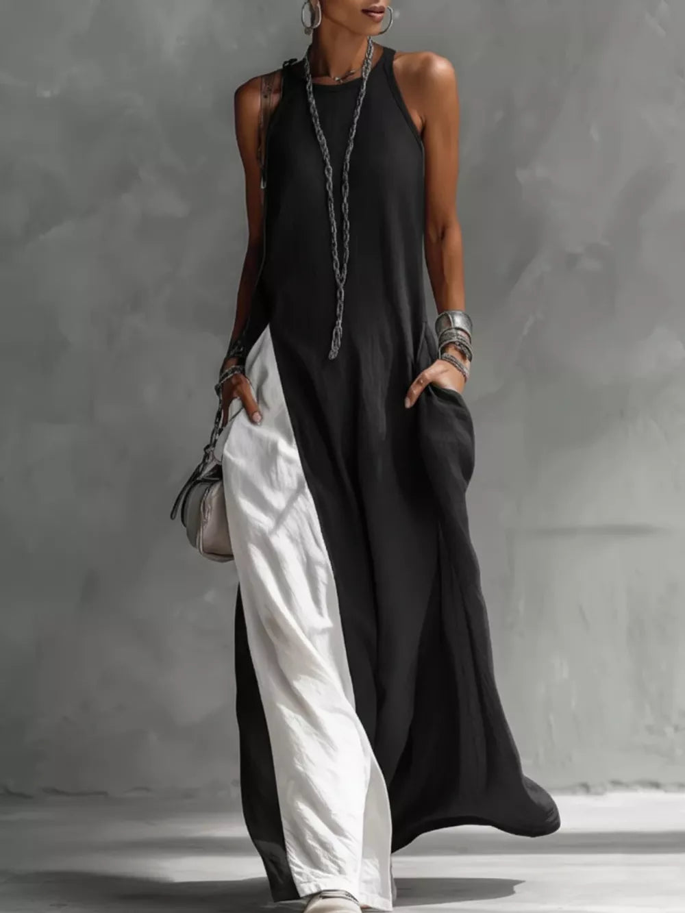 Chic two-tone black and white maxi dress with pockets and a sleeveless halter neckline.
