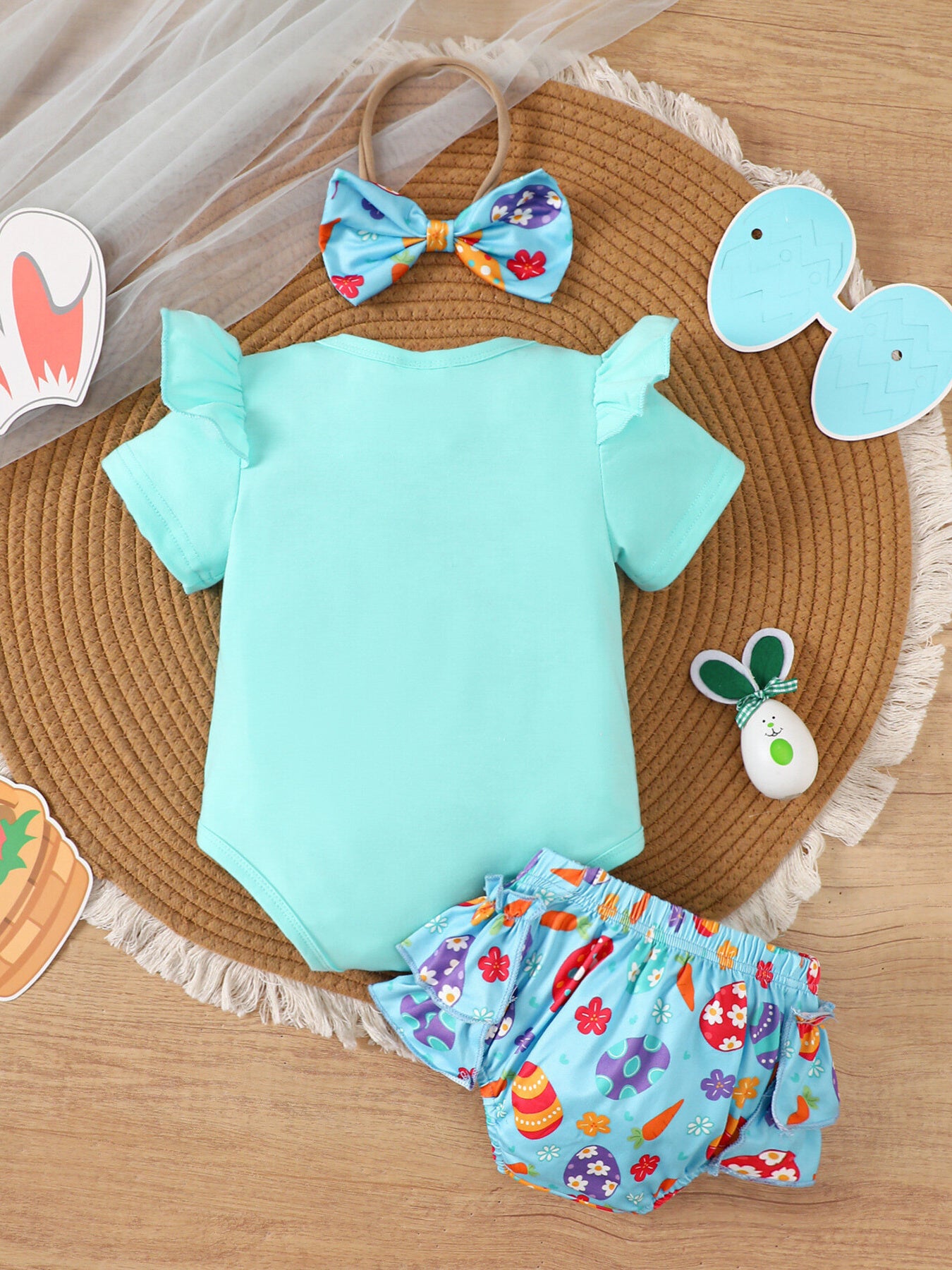 Lake blue baby bodysuit with ruffled sleeves and carrot print bloomer shorts.