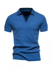 Men's blue cotton blend polo shirt with notched collar and short sleeves.