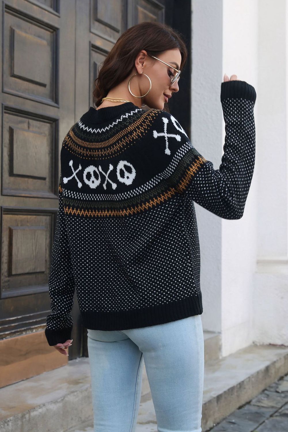Black crewneck sweater with jacquard ghost and skull pattern, acrylic knit, long sleeves.