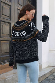 Black crewneck sweater with jacquard ghost and skull pattern, acrylic knit, long sleeves.