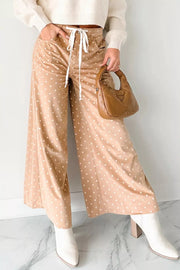 Polka dot drawstring wide-leg maternity pants in tan with white dots, ankle length.