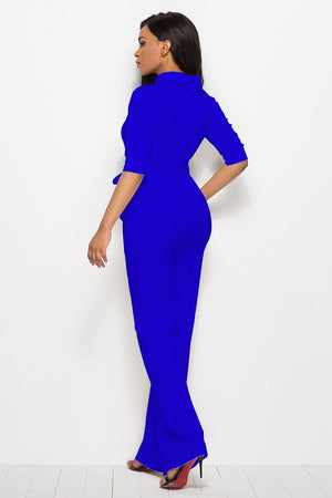 Royal blue belted palazzo jumpsuit with a high neckline and three-quarter sleeves.