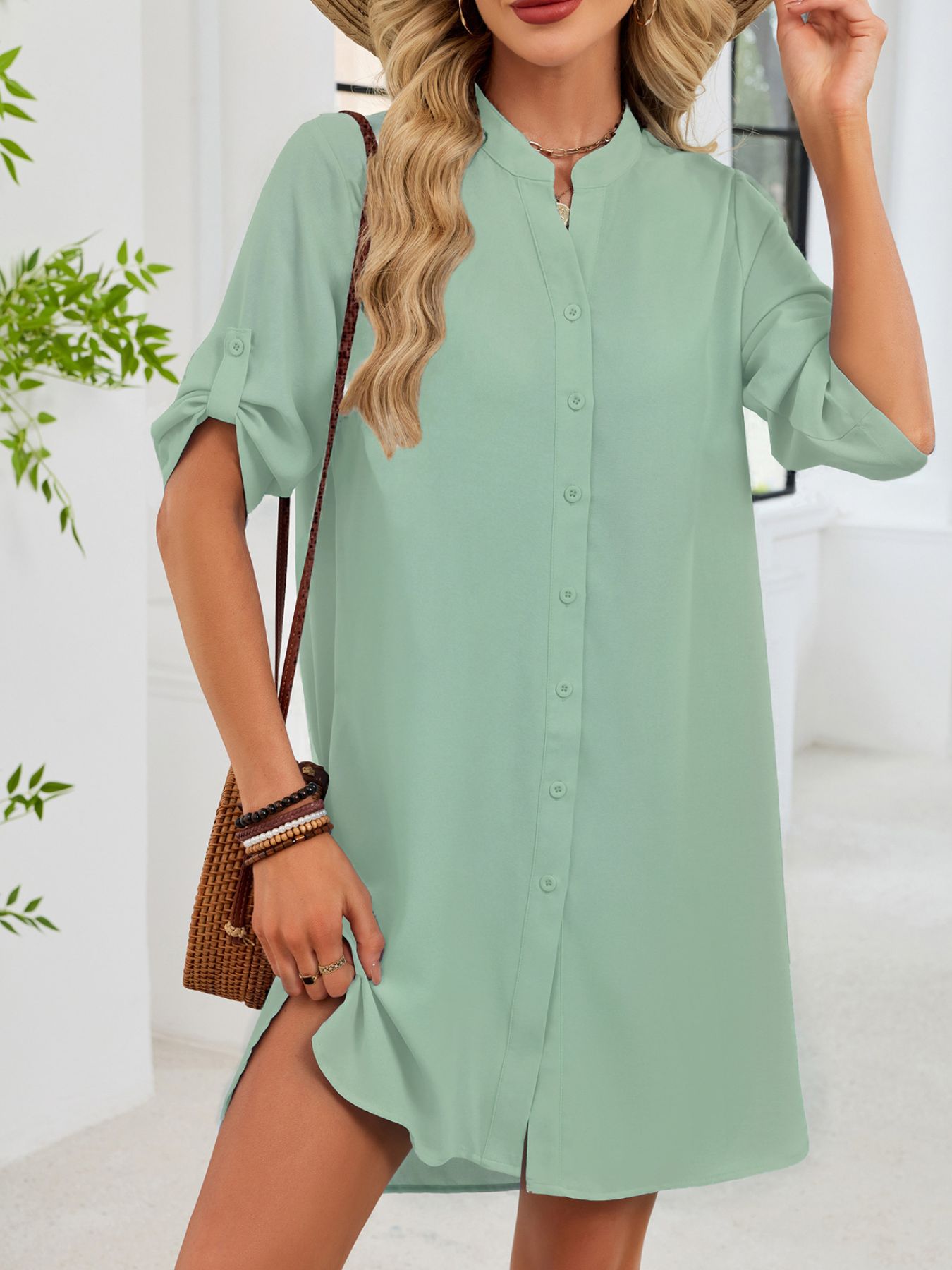 Light green button-down shirt dress with band collar and roll-tab sleeves.