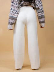 White ribbed knit palazzo trousers with a wide leg, shown from the back.