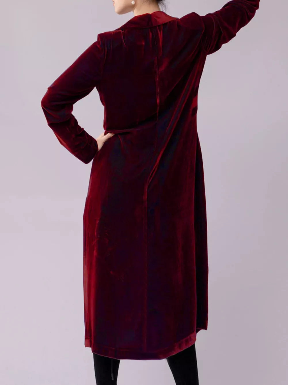 Burgundy velvet longline trench coat with draped detail.
