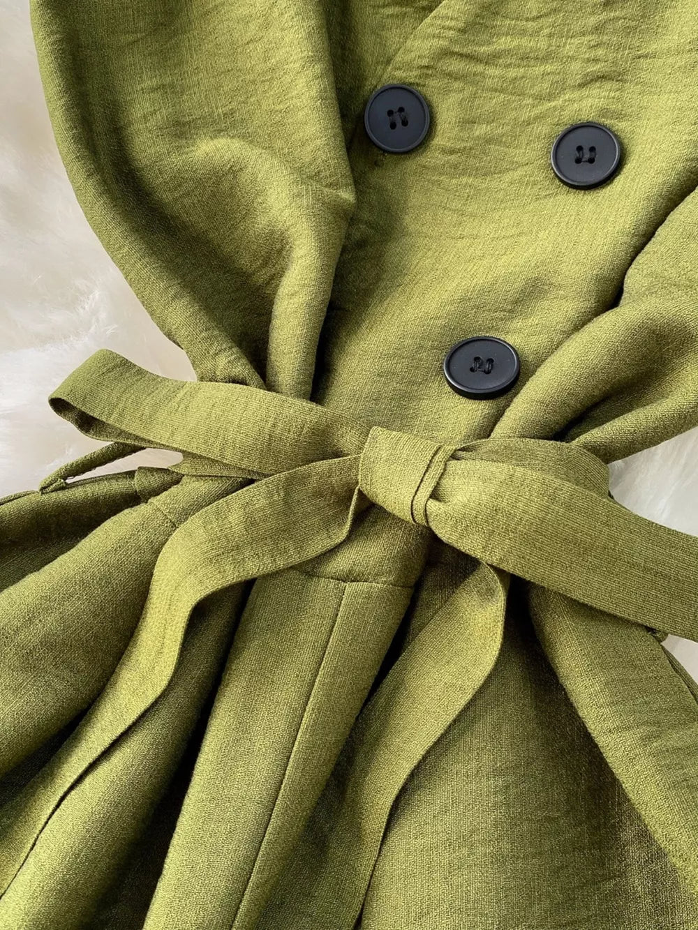 Green V-neck wide leg jumpsuit with tie belt and button details