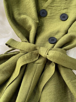 Green V-neck wide leg jumpsuit with tie belt and button details