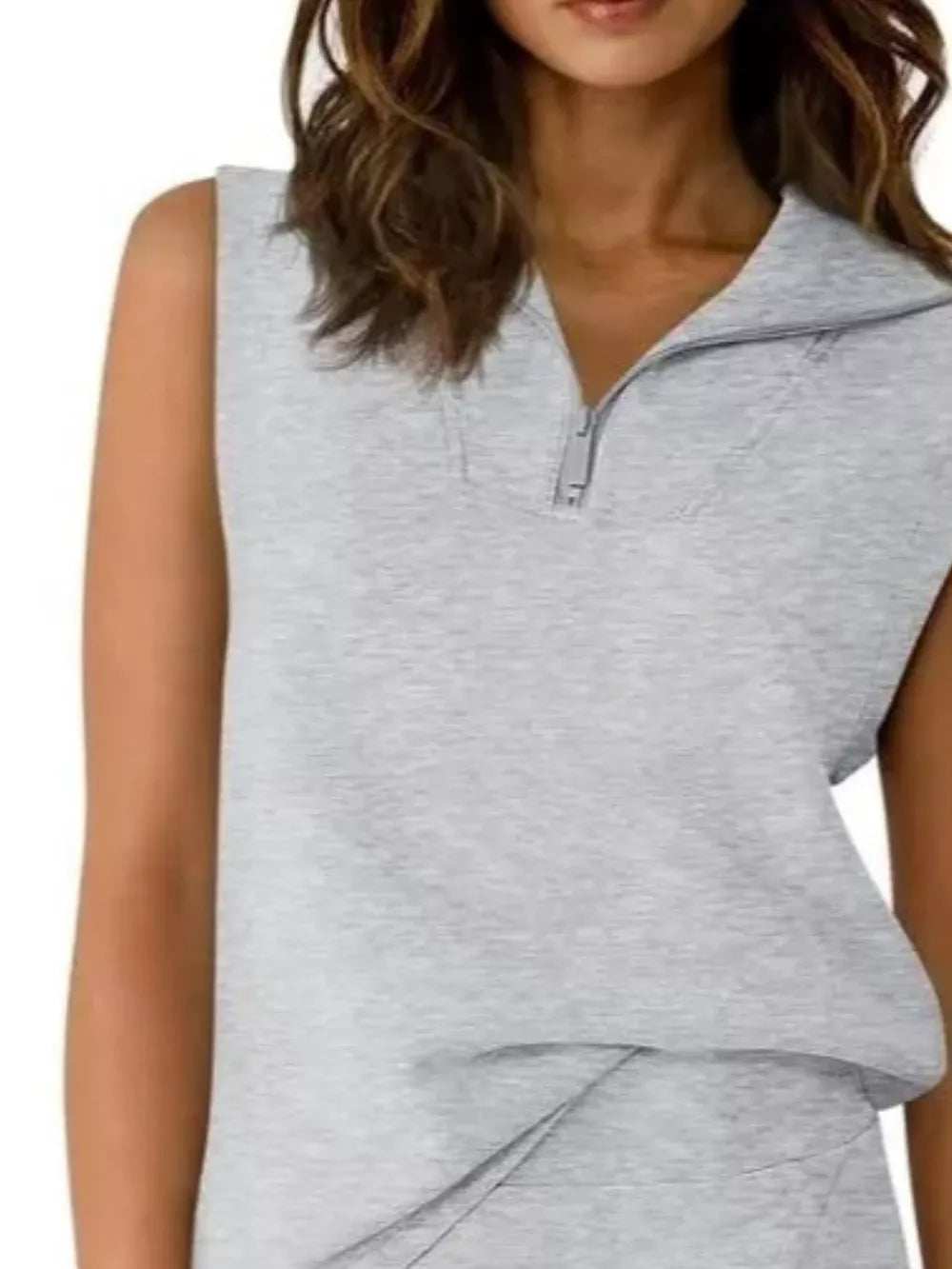 Light gray sleeveless quarter-zip top with asymmetrical skort detail
