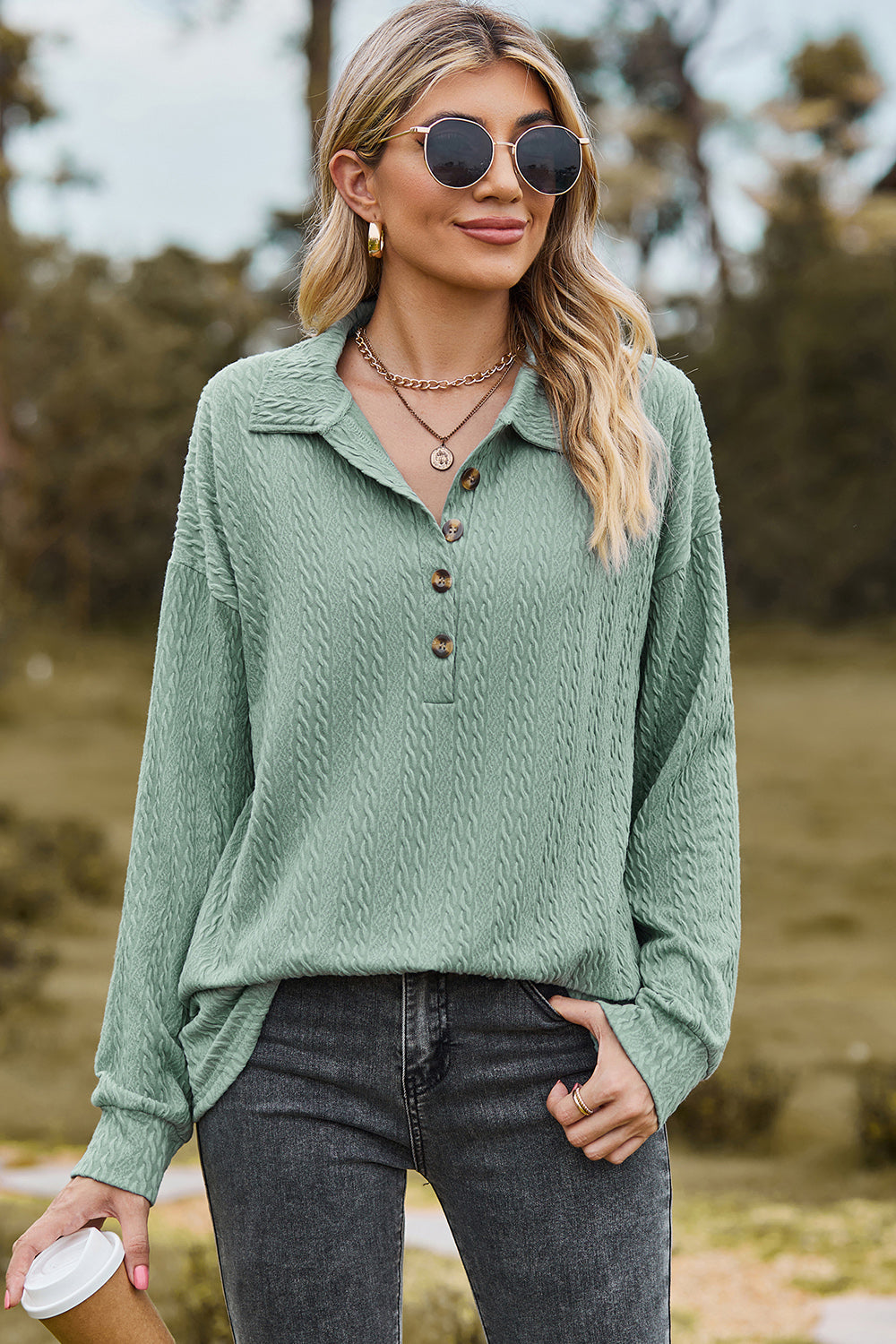 Light green textured polo-neck sweater with button detail and long sleeves.