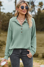 Light green textured polo-neck sweater with button detail and long sleeves.
