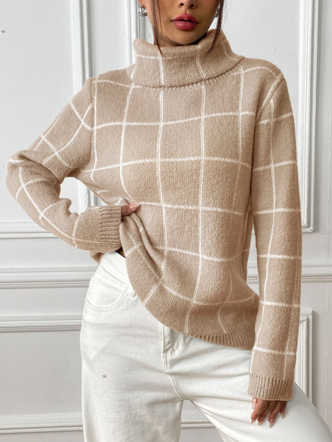 Tan grid-patterned turtleneck knit pullover sweater with long sleeves.
