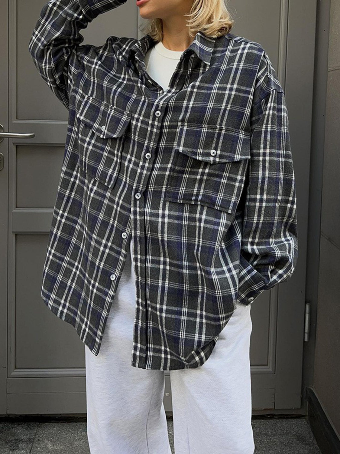 Plaid pocketed button-up shacket in dark navy with button closures and chest pockets.