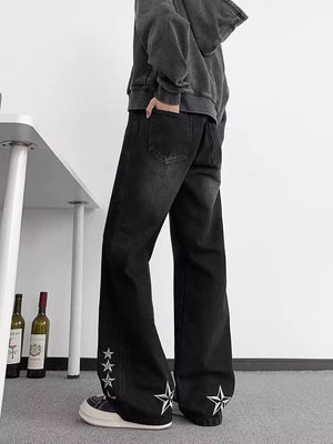 Black wide-leg men's jeans with star embroidery on the hems.