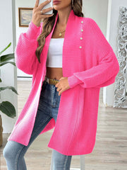 Pearl button ribbed knit cardigan in strawberry pink with a relaxed fit and open front.