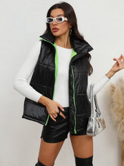 Black padded puffer vest with neon green zipper trim and stand-up collar.