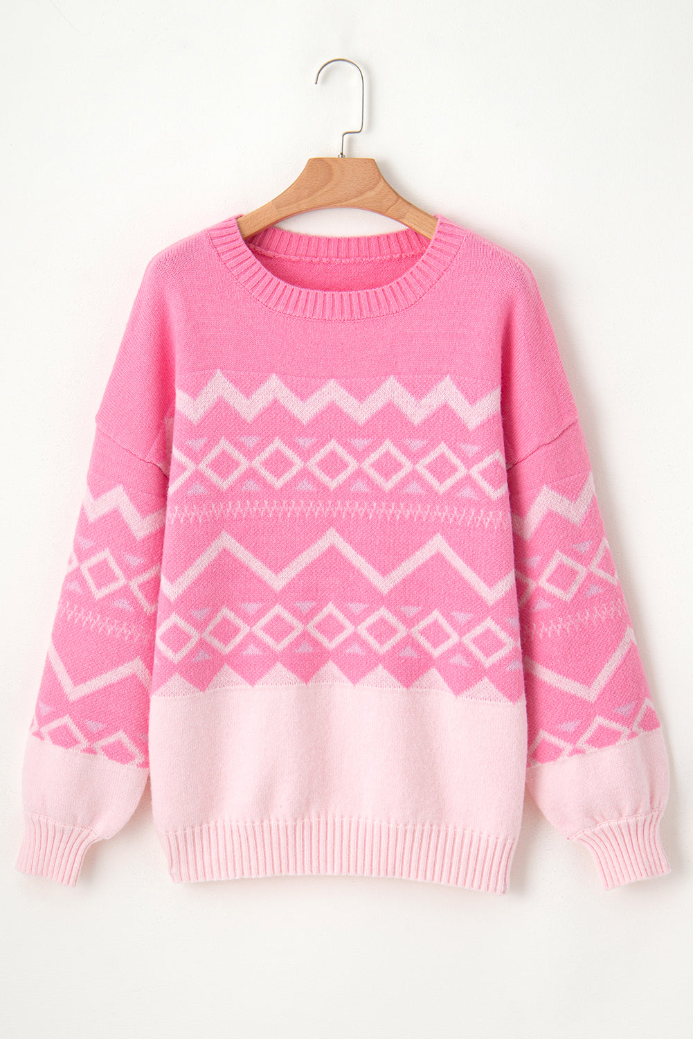 Pink acrylic knit sweater with geometric colorblock pattern, crewneck, and ribbed cuffs.