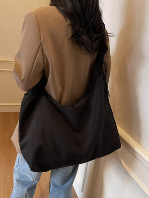 Black ruched nylon shoulder bag with zipper detail.