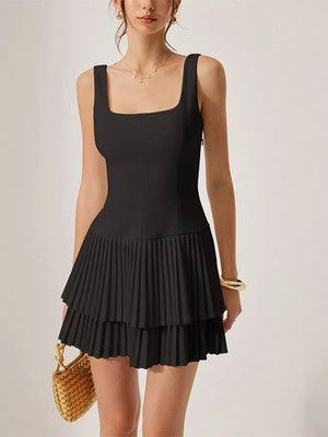 Black square neck mini dress with tiered pleated skirt and sleeveless design.