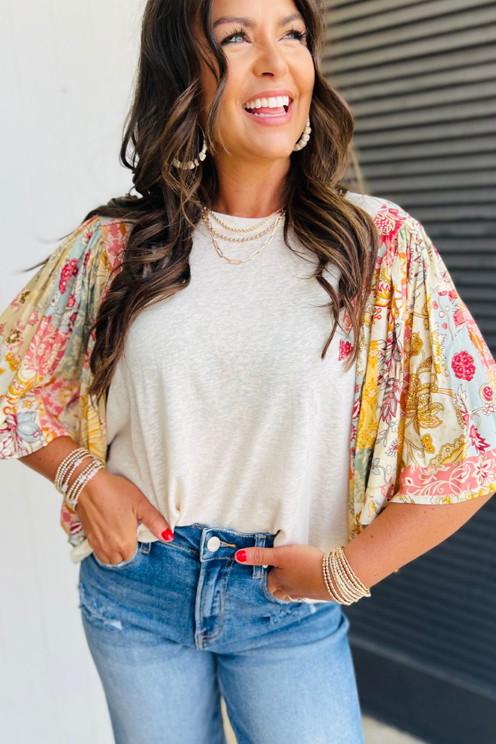 Beige t-shirt with colorful patchwork puff sleeves and a crew neck.