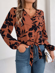 Brown floral knot-front blouse with ruffled cuffs and button-down V-neck.