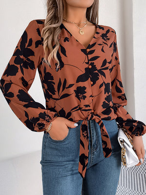 Brown floral knot-front blouse with ruffled cuffs and button-down V-neck.