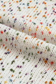 Cream speckled knit sweater with puff sleeves and a textured pattern.
