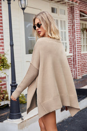 Tan acrylic sweater with asymmetric hemline and ribbed sleeves