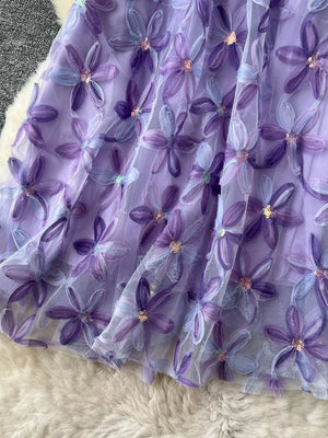 Purple layered skirt with embroidered floral appliques and sequins.
