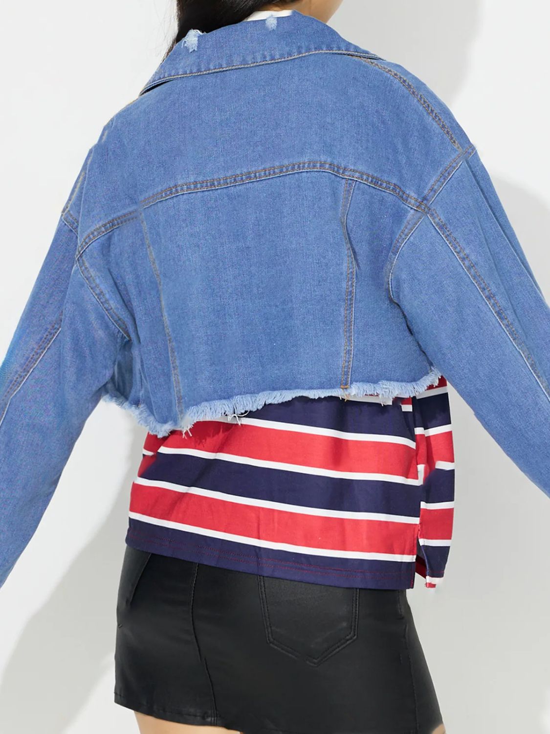 Medium wash denim trucker jacket with raw hem and collar.