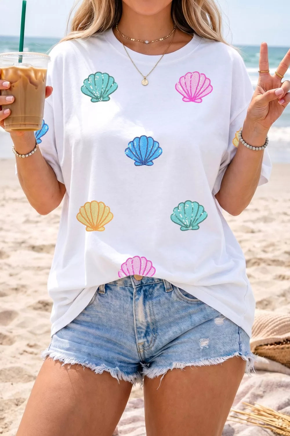 White polyester t-shirt with colorful sequin shell graphic print, crew neck, short sleeves.