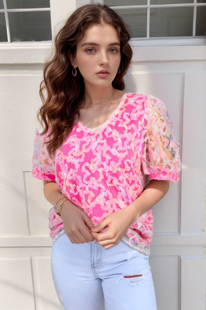 Fuchsia pink floral appliqué mesh sleeve blouse with a V-neck.