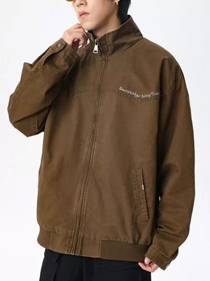 Men's brown cotton zip-up jacket with embroidered text and pockets.