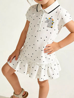 White polka dot cotton polo dress with unicorn patch and ruffled hem.