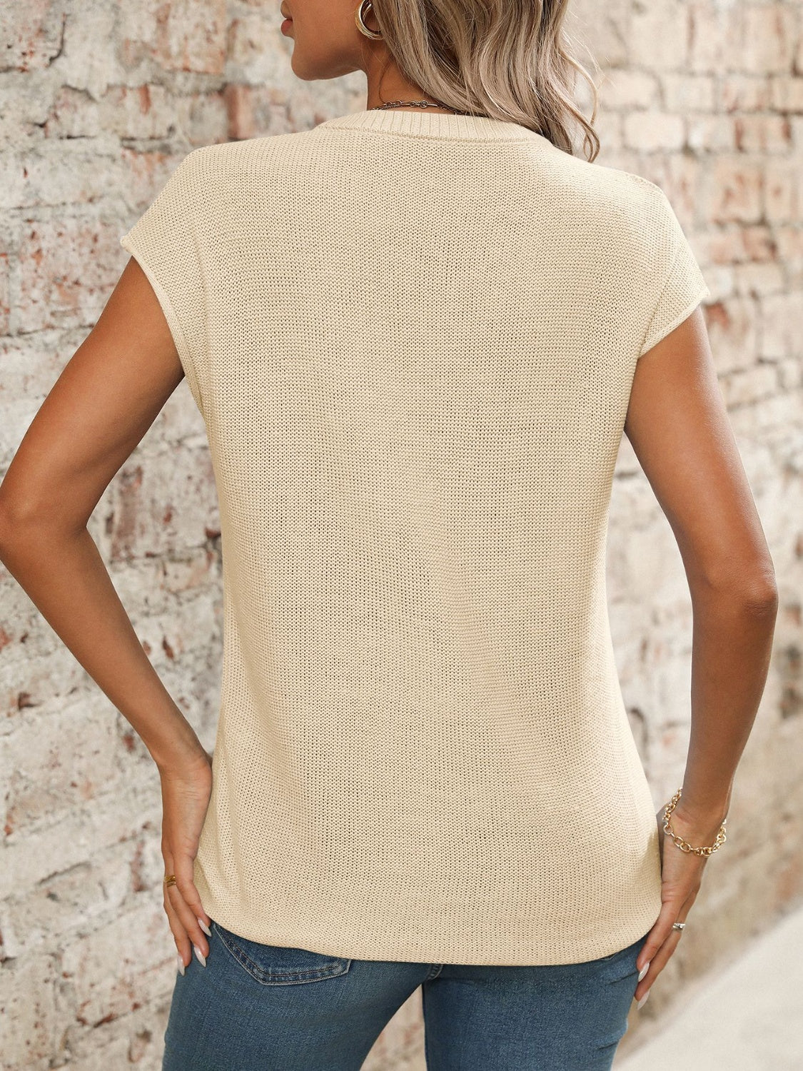 Seamed knit sleeveless v-neck top in tan with a textured stitch pattern.