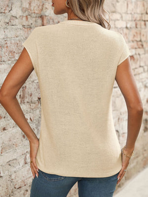 Seamed knit sleeveless v-neck top in tan with a textured stitch pattern.