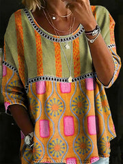 Bohemian floral t-shirt with scoop neck, short sleeves, and mixed stripe and geometric patterns in orange, yellow, pink, and
