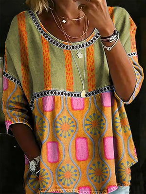Bohemian floral t-shirt with scoop neck, short sleeves, and mixed stripe and geometric patterns in orange, yellow, pink, and