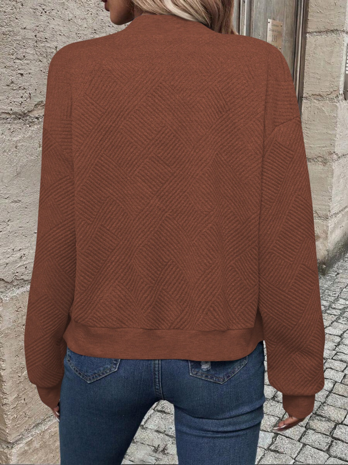Caramel bomber jacket with geometric quilted pattern and ribbed cuffs.